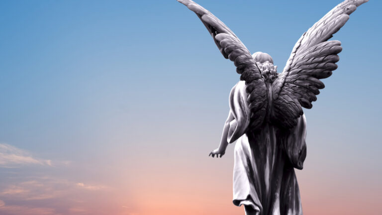 The back of a winged angel statue in the sky