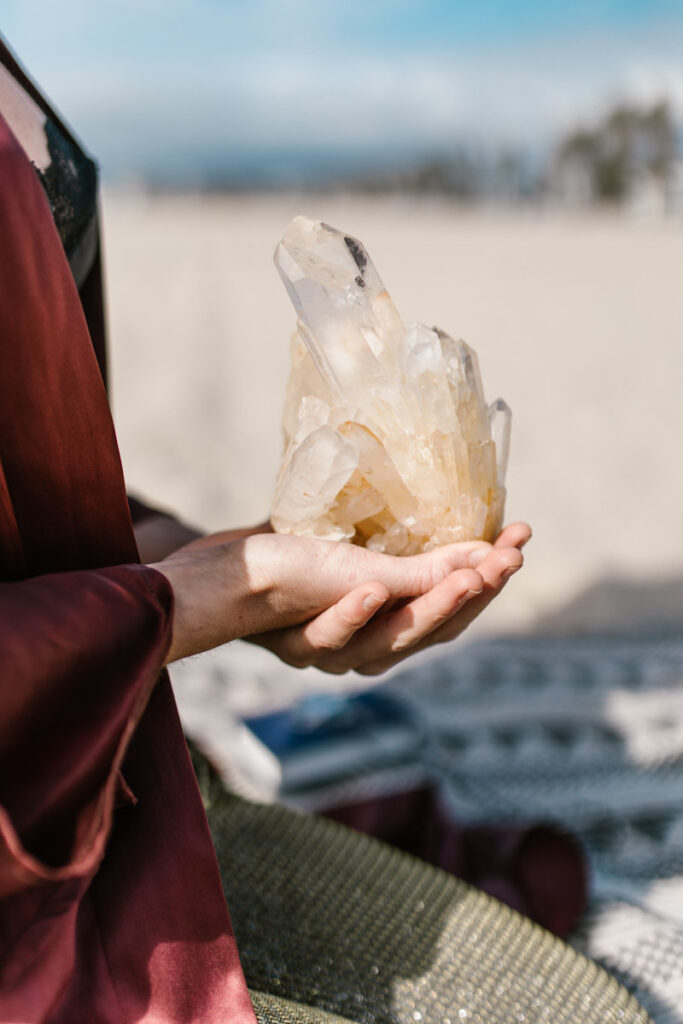 person holding libra crystals