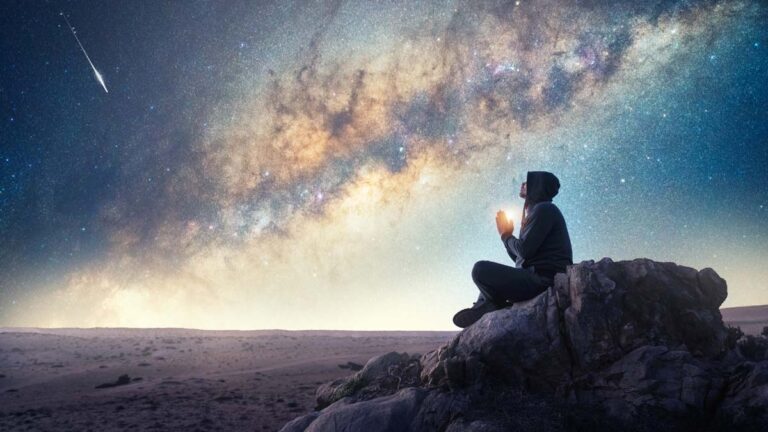 A man praying to the galaxy.
