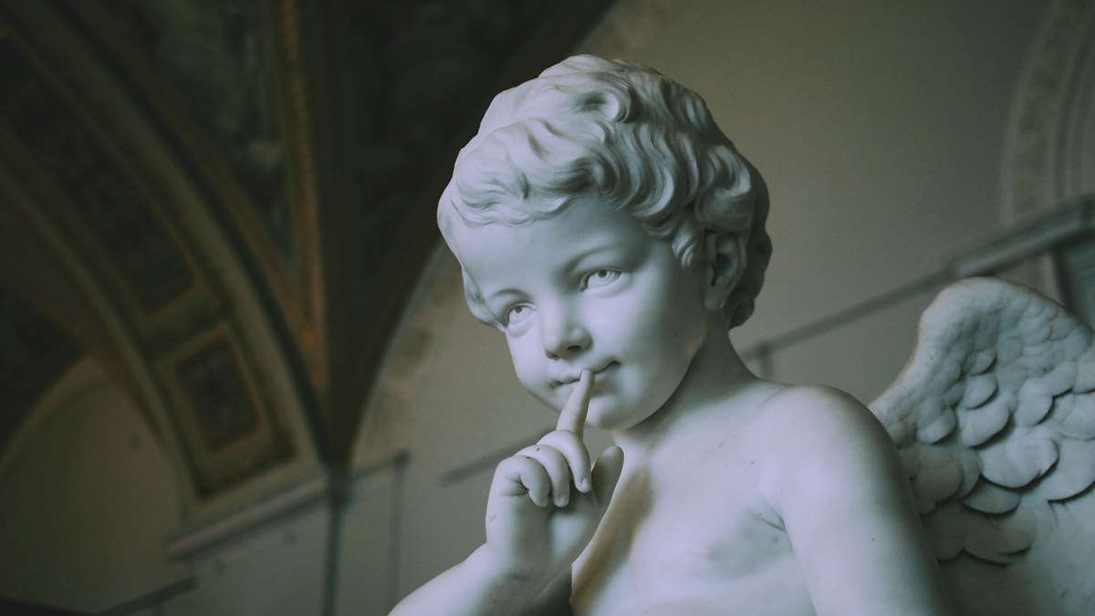 An angel statue of a boy with wings.