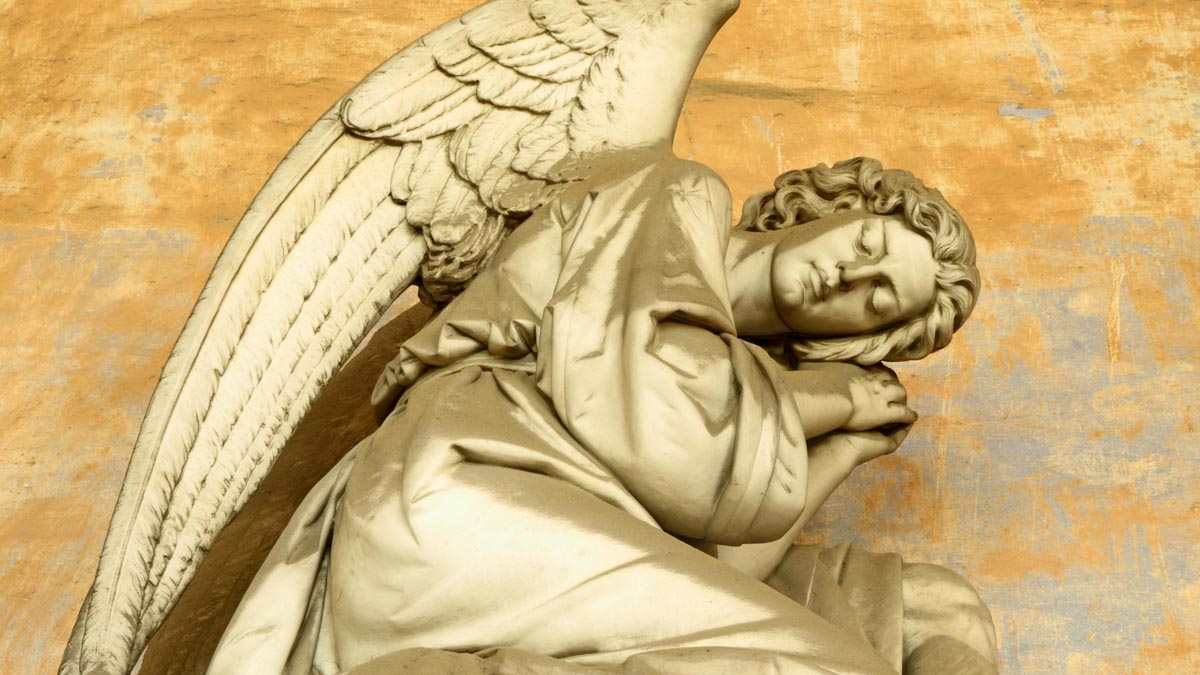 A statue of an angel resting.