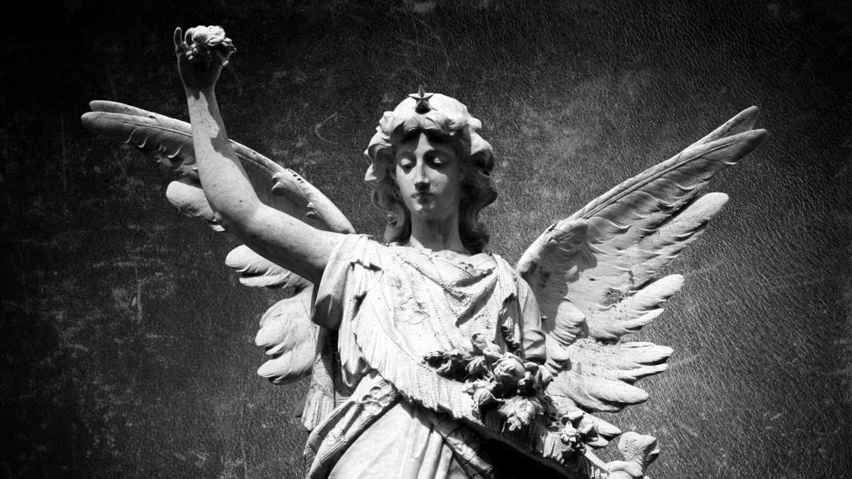 An angel statue raising their arm.