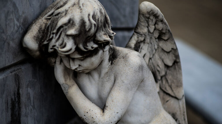 A child angel with wings appearing sad.