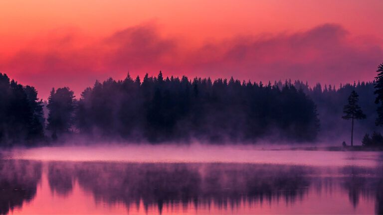 A spiritual mystic river with fog and red skies.