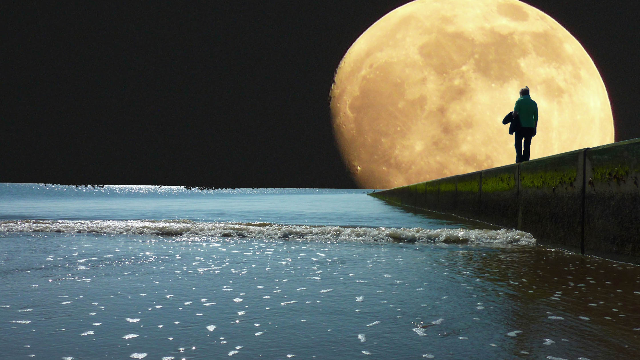 A person walking along a dock with a large moon.